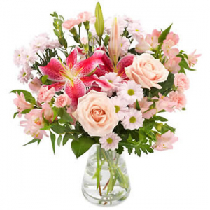  - A bouquet of seasonal pink flowers to include roses and lillies.