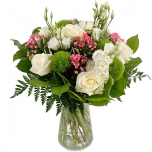  - Round short-stemmed funeral bouquet of white roses with a touch of pink and enhanced with a selection of greenery.
