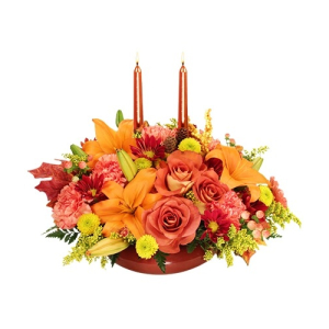  - With orange lilies, carnations, terra cotta roses, bronze daisy poms, yellow button poms and peach hypericum all the colors of the fall season are artfully placed in a bronze design bowl with tapers and fall leafs. Give thanks with flowers, order thi...