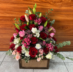 - Front facing arrangement of fresh flowers in reds pinks and whites.