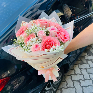  - Handtied bouquet in pink shades to include roses.
