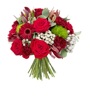 - Round bouquet composed of gerberas, roses and other seasonal flowers in shades of red.