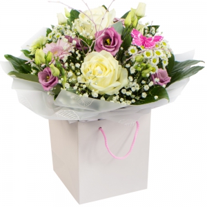  - Mother's Day Hand Tied presented in a gift bag, flowers in gorgeous pink and cream. Available for delivery on Mother's Day.   