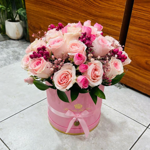  - Arrangement of pink roses with filler flowers.