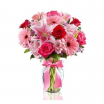  - A glass vase arrangement made of pink lily, gerbera and red rose with a pink ribbon tied around the glass vase.


